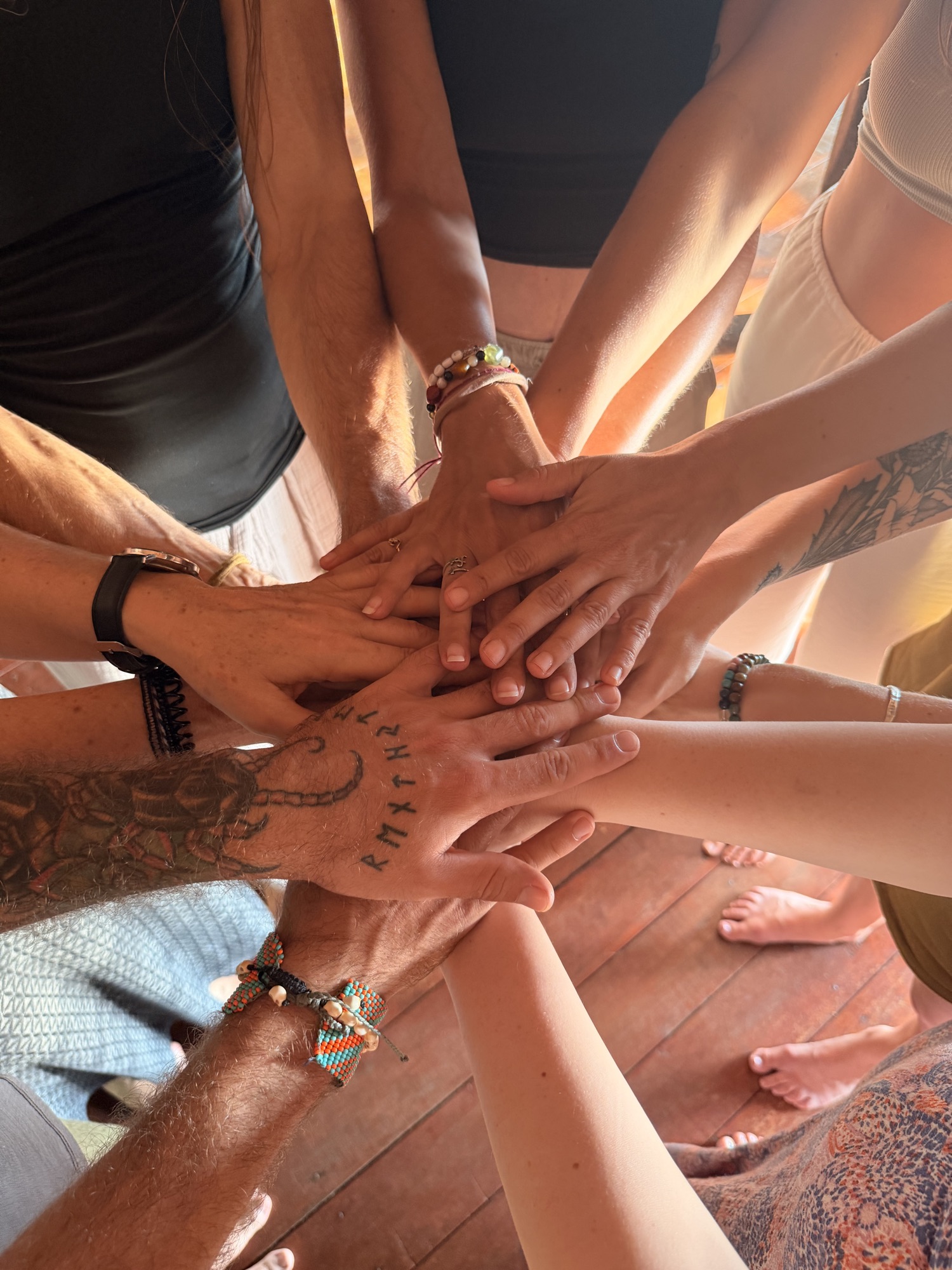 Hands stacked together in shared intention